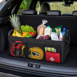 Black foldable organiser holding groceries and travel items in a car boot
