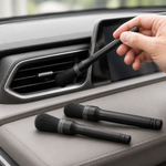 Soft car detailing brush cleaning a dashboard air vent