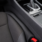 Black gap filler installed between a car seat and centre console