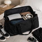 Open black travel duffel bag showing spacious storage for clothes and travel essentials
